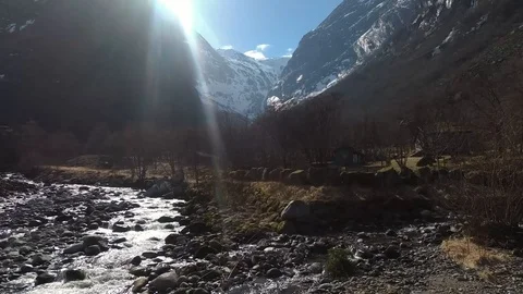 Stream River under a Snowy Peak Mountain in Norway Stock Footage 90002246