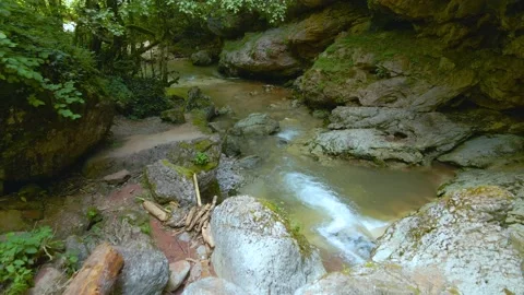 Stream running fast in summer in a mountain gorge. Small waterfall with crystal Stock Footage 201180848