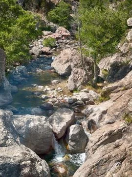 A stream running through rocks in Sardinia 스톡 사진