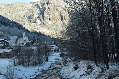A stream Running through a Small Snow covered Austrian Village Stock Photos