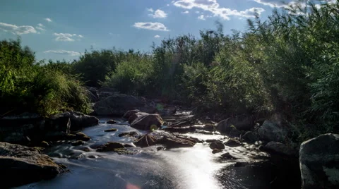 Stream running through the stones. Moving clouds Stock Footage 66526661