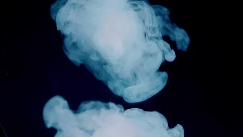 A stream of smoke descends onto a mirror surface, forming a beautiful cloud  Stock Footage 313152759