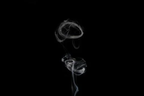 A stream of smoke on a white or black background, rises, bends and makes curls Stock Photos