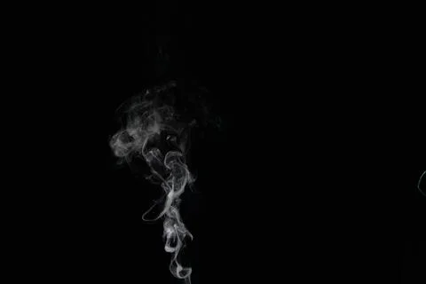 A stream of smoke on a white or black background, rises, bends and makes curls Stock Photos