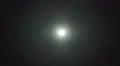 The stream of thick smoke against the background of bright light. Slow motion 4k or 4k+ Resolution