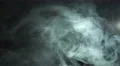 The stream of thick smoke on the background of dark surface. Slow motion capture 4k or 4k+ Resolution
