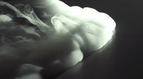 The stream of thick smoke on the background of dark surface. Slow motion capture Stock Footage 67269413