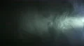 The stream of thick smoke on a dark background. Slow motion capture 4k or 4k+ Resolution