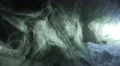 The stream of thick smoke on a dark background. Slow motion capture 4k or 4k+ Resolution