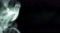 The stream of thick smoke on a dark background. Slow motion capture 4k or 4k+ Resolution