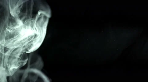 The stream of thick smoke on a dark background. Slow motion capture Video stock 67425689