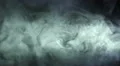 The stream of thick smoke on a dark background. Slow motion capture 4k or 4k+ Resolution