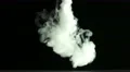 The stream of thick smoke on a dark background. Slow motion capture 4k or 4k+ Resolution