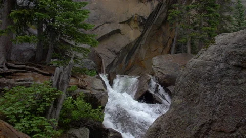 Stream through granite in rocky mountain national park 4k 60fps SLOW MOTION Stock Footage 135317612