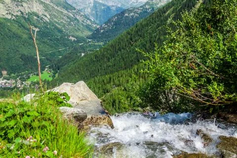 A stream trickling through rocks in the forest Stock Photos