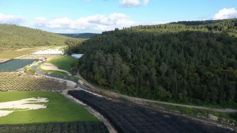 Stream in variety of fields, orchards and forest mountains Stock Footage 126946672