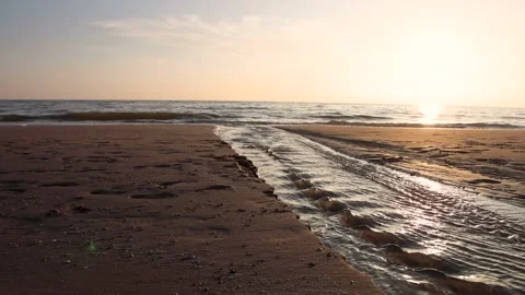 Stream of water at the beach with the sea and sundown Stock Footage 218265156