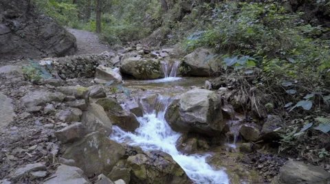Stream of water beside mountain path Stock-Footage 58500164