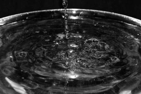 Stream of water on a black background Stock Photos