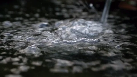 Stream of water dropping into the small stone bowl and water bubbling, macro Stock Footage 118859470