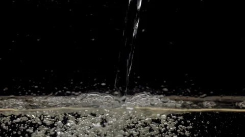 A stream of water drops down on a black background Stock Footage 118126759