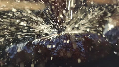 Stream of water falling on wet rock as water drops bouncing around in sunset sun Stock Footage 276079587