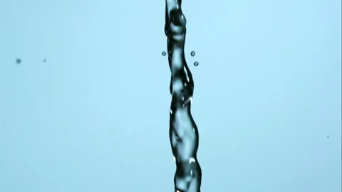 A stream of water falls and splashes into a spray of droplets Video stock 326627604