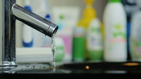 Stream of water flowing and stops flowing from an aluminum tap in the bathroom. Stock Footage 81873618