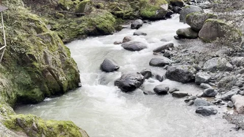A stream of water is flowing between rocks Stock Footage 296182803