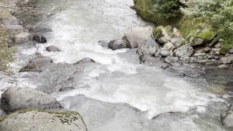 A stream of water is flowing between rocks Stock Footage 296182860