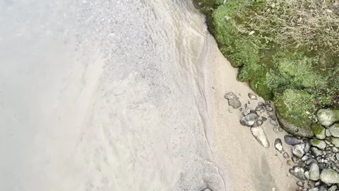A stream of water is flowing between rocks Stock Footage 296182957