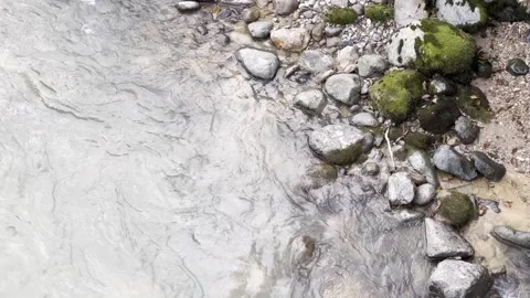 A stream of water is flowing between rocks Stock Footage 296182963