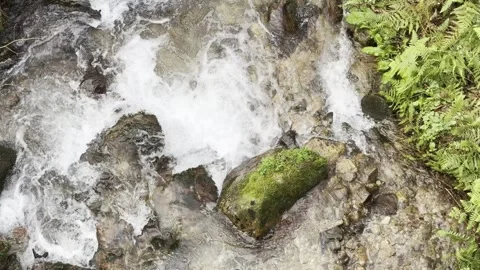 A stream of water is flowing between rocks Stock Footage 296183118