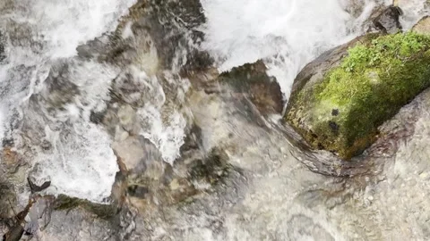 A stream of water is flowing between rocks Stock Footage 296183166