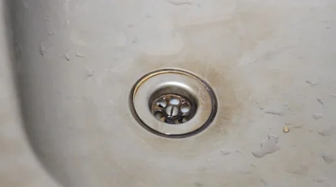 Stream of water flowing down the drain in the sink Stock Footage 49545528