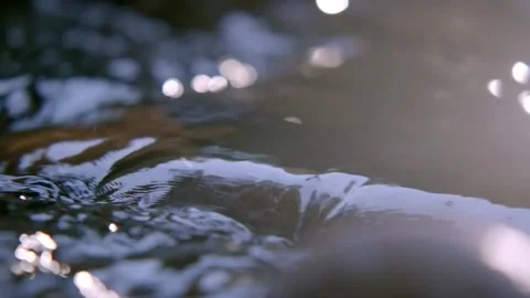 Stream water flowing over rocks. Video stock 306286911
