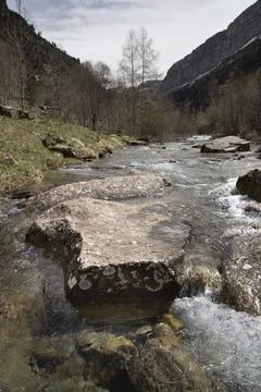 Stream water flowing over rocks in a mountain canyon Stock Photos