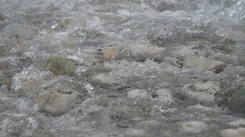 A stream of water flowing over stone surface. Stock Footage 145084188