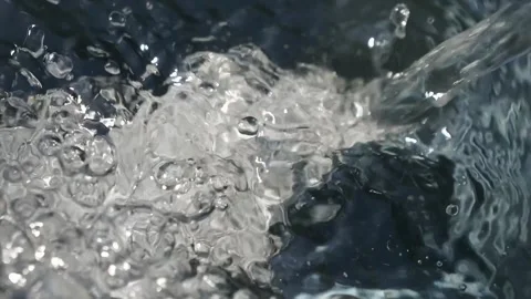 A stream of water flows into a container and boils. A stream of clean water.. Stock Footage 337768439