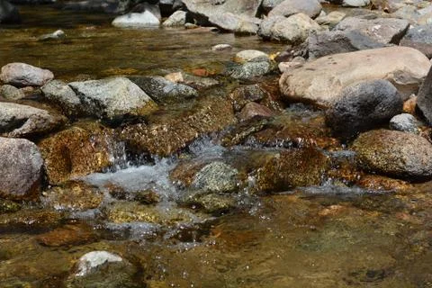 Stream Water Flows Over Rocks Stock Photos