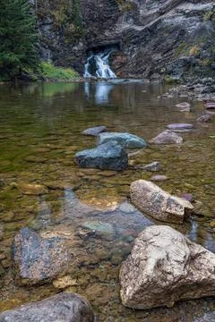 A stream of water flows through a rocky area Stock Photos