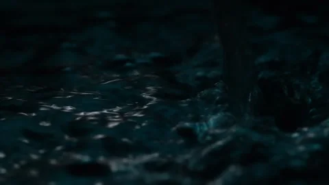 Stream of Water Pouring into Dark Pool. Stock Footage 276091855