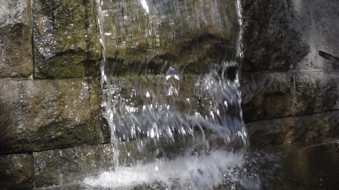 Stream of water pouring down a stone in slow motion Stock Footage 141286857
