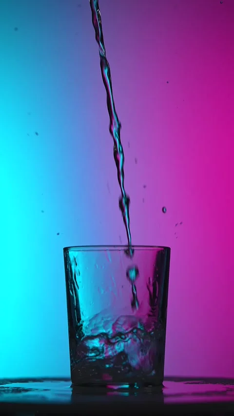 Stream of Water Pouring Into Glass on Gradient Background Stock Footage 332542027