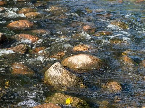 A stream of water with rocks in it Stock Photos