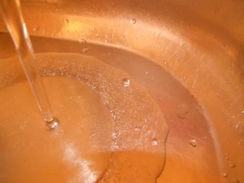 A stream of water in the sink Stock Photos