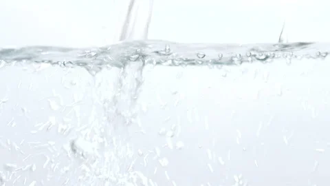 Stream of water in slow motion falls on  clean surface creating air bubbles 動画素材 140248371