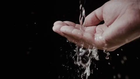 A stream of water splashing flows into his hands. Slow mo Stock Footage 74761800