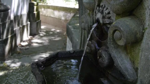 A stream of water from a stone wall Stockbeeldmateriaal 80248496