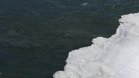 Stream of water under thin ice in the river Stock Footage 84966976